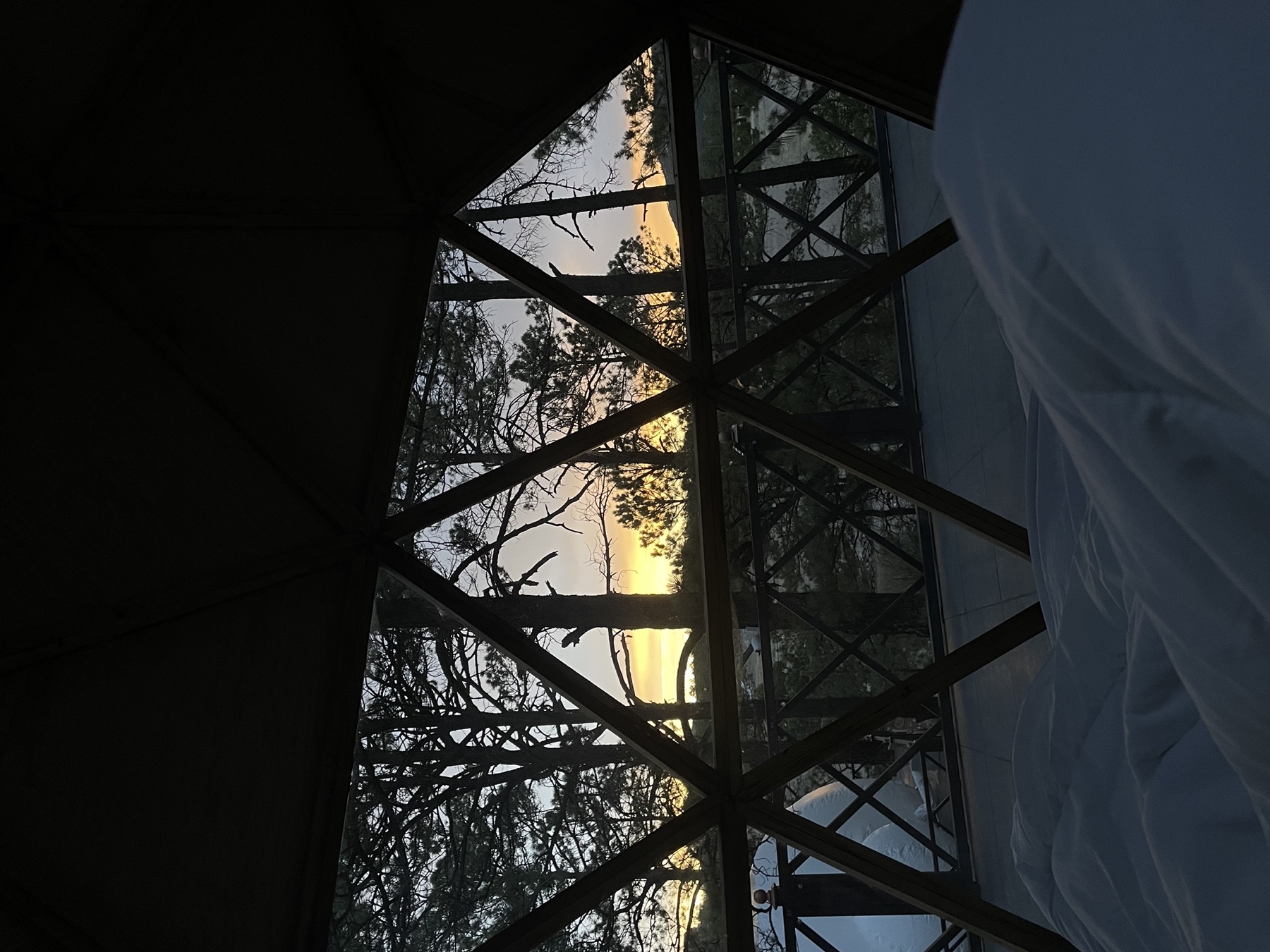 Atardecer visto desde la cama dentro de un domo geodésico